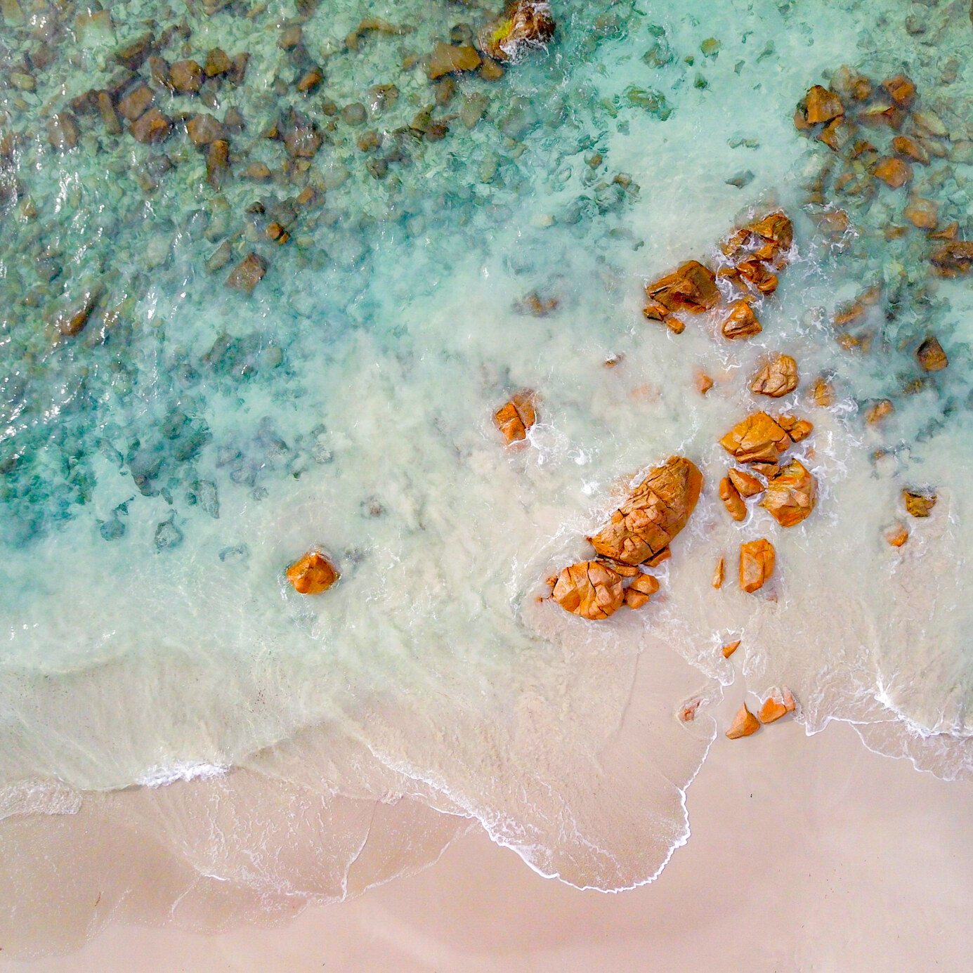 An aerial image of a shallow beach with the rocks and water forming patterns Leeuwin-Naturaliste National Park Western Australia
