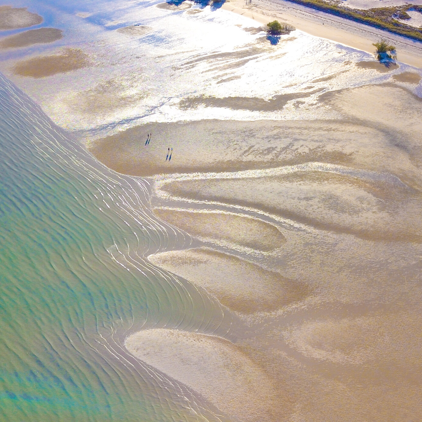 The light plays on the water in an aerial photo of the shallows of Cygnet Bay near Broome in Western Australia