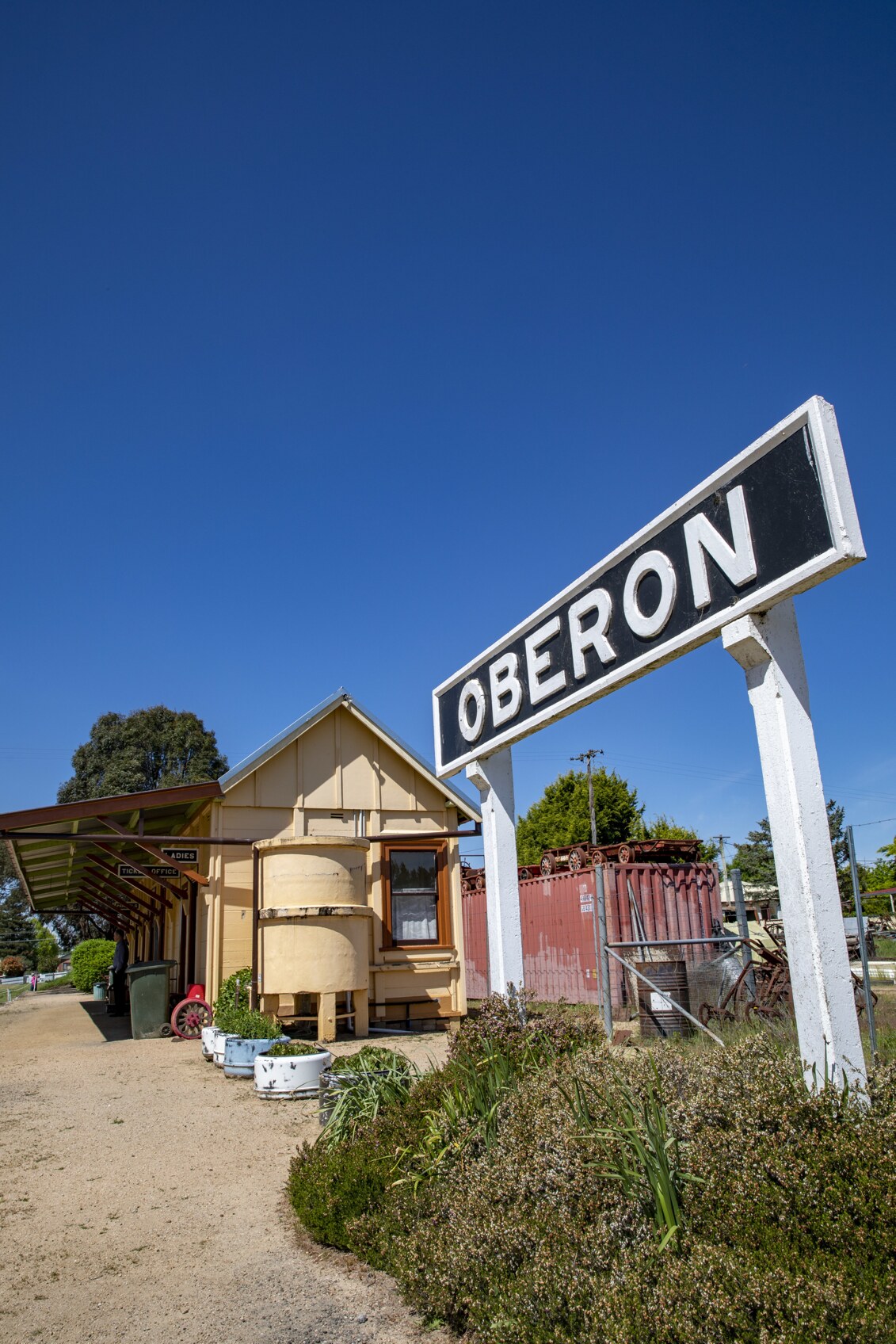 Oberon Town sign photographed against a deep blue summer sky in NSW