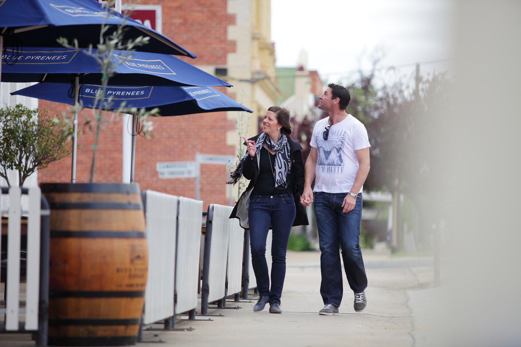 A couple choosing where to eat on the main street of Avoca, Victoria