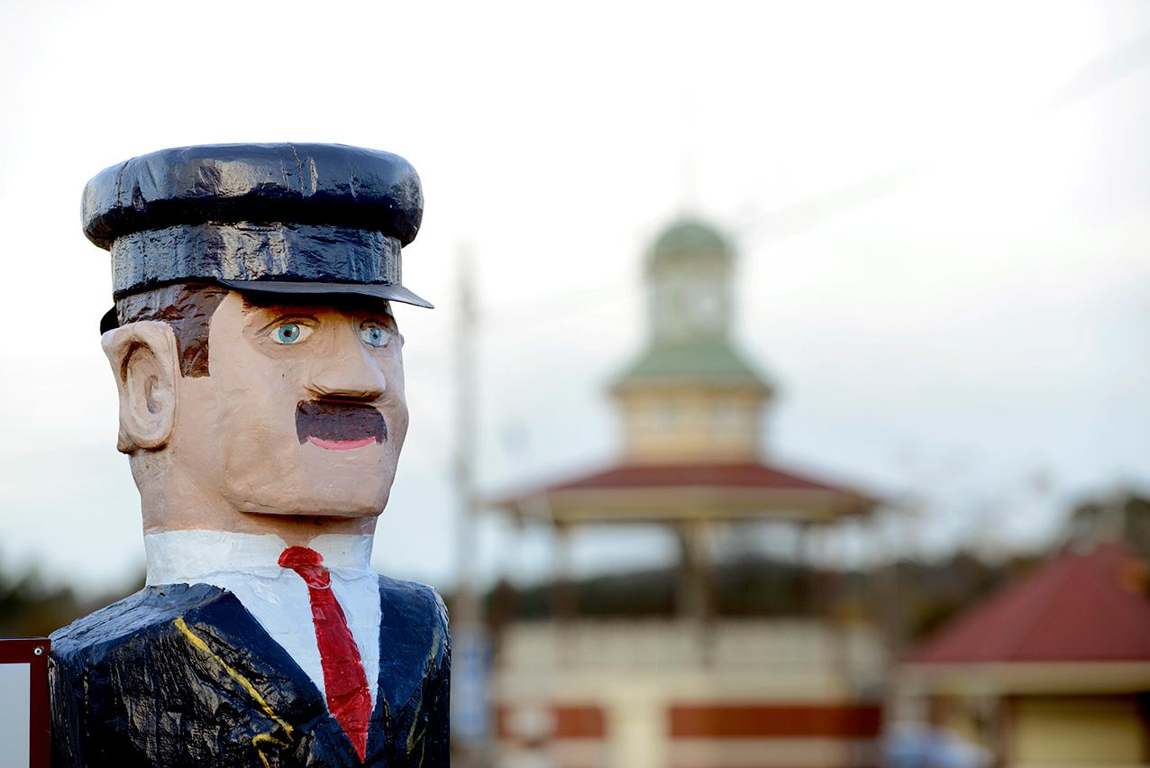 An old statue of a ticket taker stands guard over a rotunda in a park in Pyrenees Victoria