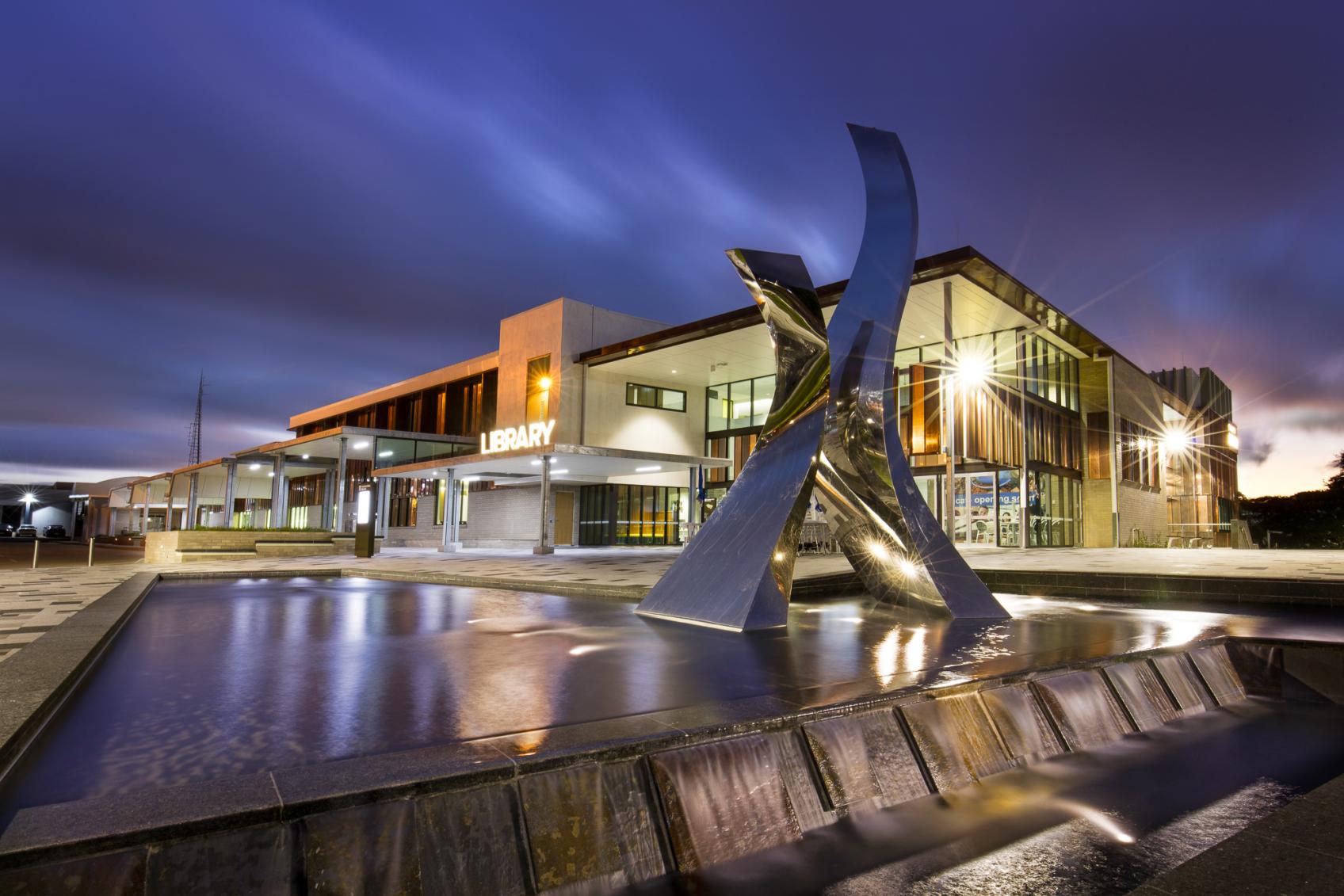 Toowoomba Regional Library shot in early evening dusk with light shining on the pond in the forecourt